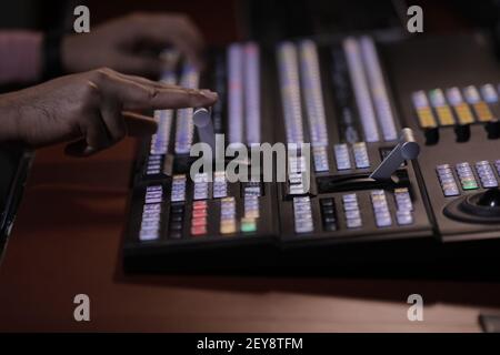 Close up hand on video switcher panel. video mixer Stock Photo