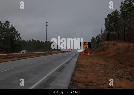 Augusta, Ga USA - 01 31 21: LED warning sign Traffic on a rural highway with construction cones and signs Stock Photo