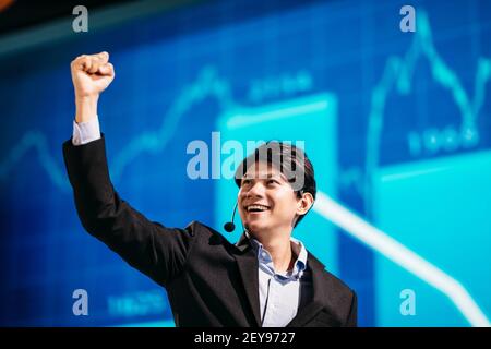 Asian Businessman Stands on Stage for Business Presentation Stock Photo