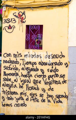 Madrid Spain Spanish Centro District Lavapies historic center Calle de Argumosa neighborhood street art graffiti poem Spanish language Stock Photo