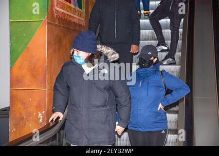 NEW YORK, NY - MARCH 05: A moviegoer takes an escalator at the AMC Loews Lincoln Square on March 05, 2021 in New York City. AMC Theatres reopened its New York area locations today, with new safety precautions in place, for the first time since closing in March because of the coronavirus (COVID-19) pandemic. Stock Photo