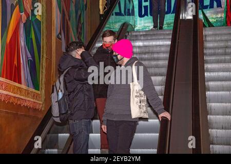 NEW YORK, NY - MARCH 05: A moviegoer takes an escalator at the AMC Loews Lincoln Square on March 05, 2021 in New York City. AMC Theatres reopened its New York area locations today, with new safety precautions in place, for the first time since closing in March because of the coronavirus (COVID-19) pandemic. Stock Photo