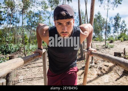 A handsome sportsman doing cardio exercises in nature Stock Photo