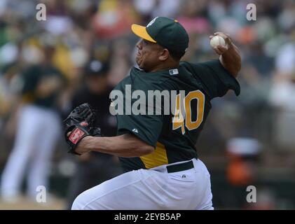 Oakland A's pitcher Bartolo Colon throws to the Seattle Mariners