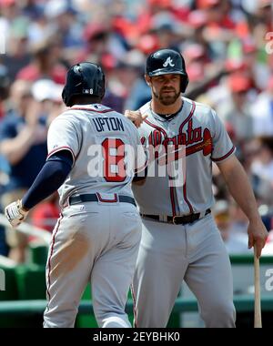 Atlanta Braves' Evan Gattis, right, high-fives teammate Tommy La Stella  after hitting a home run in the second inning of a baseball game against  the Miami Marlins, Sunday, Aug. 31, 2014, in