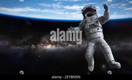 astronaut in front of planet Earth Stock Photo