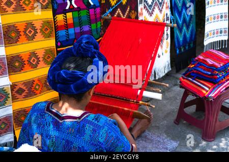 A Mayan woman weaving a tablecloth with her waist loom in San Antonio Palopo, Guatemala Stock Photo