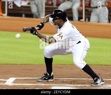 Miami Marlins Juan Pierre (9) takes a bunt against the New York Mets during  a spring training game at the Roger Dean Complex in Jupiter, Florida on  March 3, 2013. Miami defeated