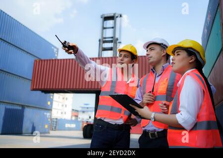 Asian workers man are explaining the container inspection to the supervisor in container depot terminal. Stock Photo