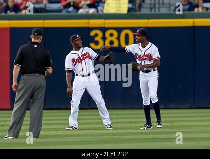 Atlanta Braves' B.J. Upton, right, celebrates with Freddie Freeman after  scoring on a single hit by Andrelton Simmons during the third inning of a  baseball game against the Chicago Cubs in Chicago