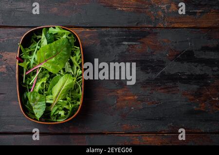 Mix Salad leafs, Swiss chard and Arugula set, on old dark wooden table background, top view flat lay, with copy space for text Stock Photo