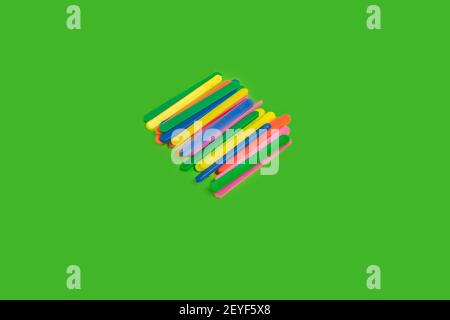 multicolored counting sticks on a green background Stock Photo