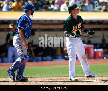 Oakland Athletics' Josh Donaldson reacts while batting while Seattle  Mariners catcher Mike Zunino picks up the ball during a baseball game in  Seattle on Saturday, Sept. 28, 2013. (AP Photo/John Froschauer Stock