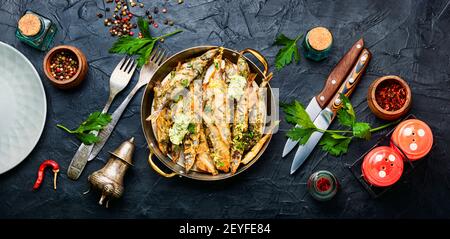 Fried capelin fish with herbs and lemon zest Stock Photo