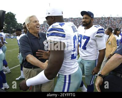 Former Dallas Cowboys head coach Jimmy Johnson, left, hands Florida running  back Emmitt Smith his No. 22 jersey as the Cowboys 1990 No. 1 draft pick is  introduced at the Cowboys training