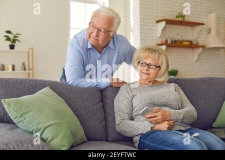 Happy senior husband and wife staying at home and enjoying their free time together Stock Photo