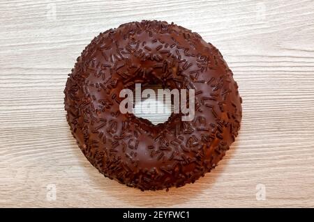 Donut with chocolate icing on the table. Delicious food, pastries Stock Photo