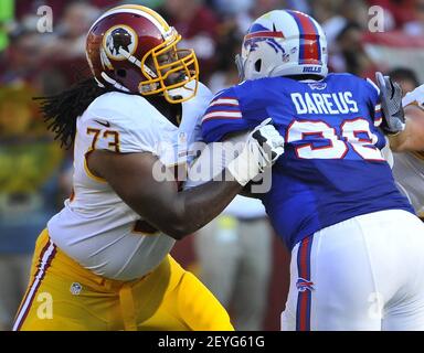 Buffalo Bills defensive tackle Marcell Dareus, center, passes Baltimore  Ravens tackle Michael Oher (74) to sack Ravens quarterback Joe Flacco (5)  during the second quarter at Ralph Wilson Stadium in Orchard Park