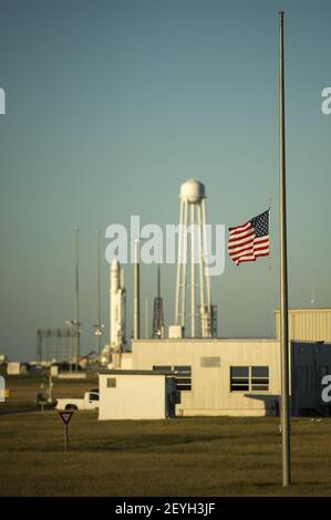 A United States flag is flown at half-staff just outside the Mid-Atlantic Regional Spaceport (MARS) Pad-0A with the Orbital Sciences Corporation Antares rocket, Tuesday, Sept. 17, 2013, NASA Wallops Flight Facility, Virginia. President Obama directed Monday that flags be lowered to half-staff to pay tribute to the victims of 'the senseless acts of violence' perpetrated at the Washington Navy Yard. NASA's commercial space partner, Orbital Sciences Corporation, is targeting a Sept. 18 launch of the Cygnus cargo spacecraft, demonstration cargo resupply mission, to the International Space Station.