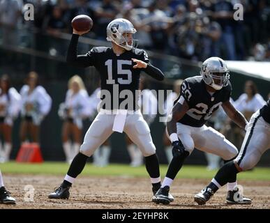 Oakland Raiders QB Matt Flynn (15) has his jersey pulled by the Washington  Redskins in the third quarter at O.co Coliseum in Oakland, California on  September 29, 2013. The Redskins defeated the