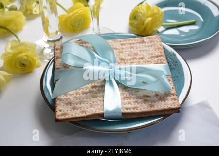 Table served for Passover (Pesach) indoors, with matzah bread as symbolic Pesach (Passover Seder) item. Stock Photo