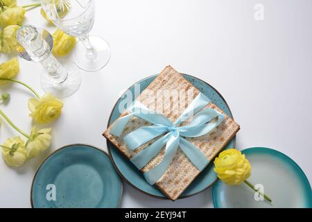 Table served for Passover (Pesach) indoors, with matzah bread as symbolic Pesach (Passover Seder) item. Stock Photo
