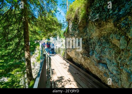 Tourists at the Marienbrücke (Mary's Bridge), a pedestrian bridge allowing a stunning view of Neuschwanstein Castle, near Füssen, Bavaria, Germany Stock Photo