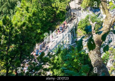 Tourists at the Marienbrücke (Mary's Bridge), a pedestrian bridge allowing a stunning view of Neuschwanstein Castle, near Füssen, Bavaria, Germany Stock Photo