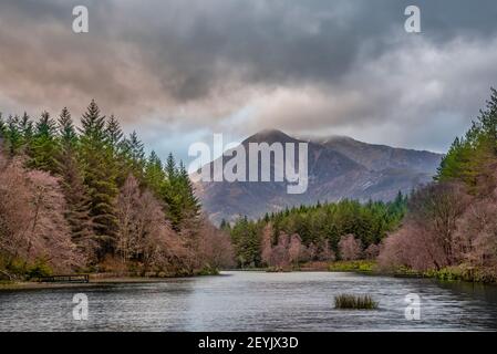 Beautiful landscape image of Glencoe Lochan with Pap of Glencoe in the distance on a Winter's evening