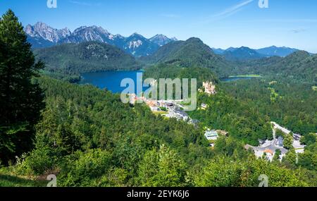 Hohenschwangau Castle next to the lakes Schwansee and Alpsee, embedded within a beautiful and stunning alpine landscape in Bavaria, Germany, Europe Stock Photo