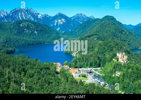 Hohenschwangau Castle next to the lakes Schwansee and Alpsee, embedded within a beautiful and stunning alpine landscape in Bavaria, Germany, Europe Stock Photo