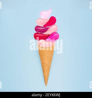 Creative concept of lipstick smeared in the form of popsicle ice cream on a white background. Flat lay of colorful swatches makeup product Stock Photo