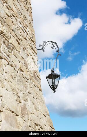 Heavy steel black lantern on old castle wall. Graphic resources Stock Photo