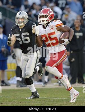 Oakland Raiders defensive end Justin Tuck (91), middle linebacker Miles  Burris (56) and safety Charles Woodson (24) surround Kansas City Chiefs  tight end Travis Kelce (87) as he picks up a first