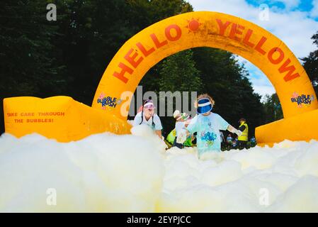 BOLTON, UNITED KINGDOM - Jul 14, 2018: A selection of event Photos from the BubbleRush charity foam party race for Bolton Hospice with runners racing Stock Photo