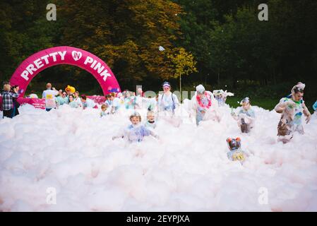 BOLTON, UNITED KINGDOM - Jul 14, 2018: A selection of event Photos from the BubbleRush charity foam party race for Bolton Hospice with runners racing Stock Photo