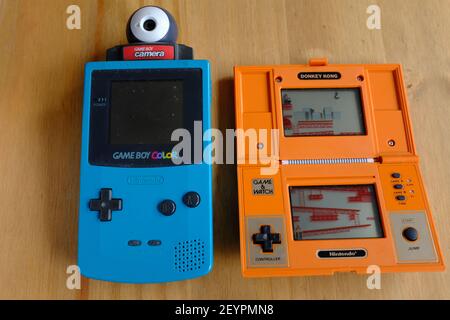 LONDON - 6TH MARCH 2021: The 1982 Nintendo Game and Watch Donkey Kong console and 1998 Gameboy Color with the Gameboy Camera. Stock Photo
