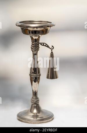 Silver candle holder with candle snuffer. Stock Photo