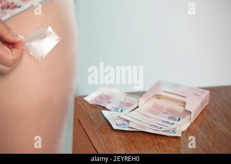 London, UK, 6 March 2021: A menopausal woman puts on an oestrogen patch for hormone replacement therapy (HRT) on her upper thigh. There is some evidence that oestrogen also has protective effects against the worst symptoms of covid-19 caused by the novel coronavirus. Anna Watson/Alamy Stock Photo