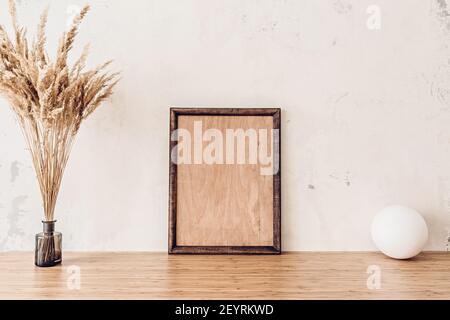 Wooden frame mockup on bamboo table for your artwork Stock Photo