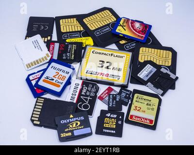 COTTBUS, GERMANY - Jan 17, 2021: Memory cards from different times lie on white surface Stock Photo