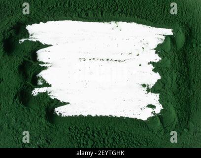 Spirulina powder on a white plate with place for text. Superfood concept. Horizontal orientation. Top view. Copy space. Stock Photo