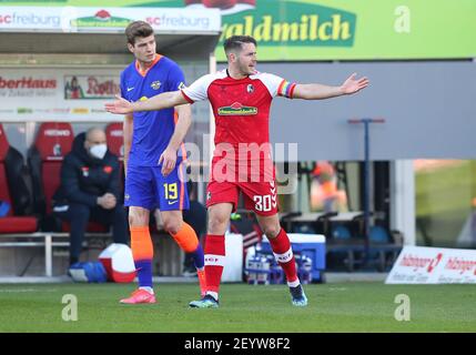 Freiburg Im Breisgau, Germany. 06th Mar, 2021. Football: Bundesliga, SC Freiburg - RB Leipzig, Matchday 24 at Schwarzwald-Stadion. Freiburg's defender Christian Günter (r) gestures in front of Leipzig's striker Alexander Sörloth. Credit: Tom Weller/dpa/Alamy Live News Stock Photo