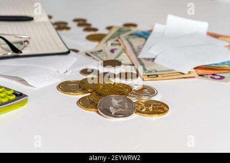 money, calculator, pen, paper, notebook and glasses on white background, financial analytics concept, calculating budget, flat lay, close-up Stock Photo