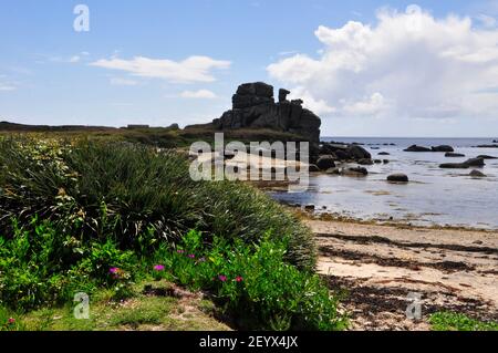 Tide going out from Porth Hellick passing the rock formation known as the Loaded Camel on the island of St Mary's, isles of Scilly,Cornwall.UK Stock Photo