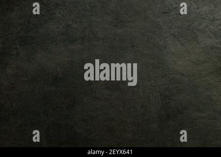 Dark concrete textured wall background.black cement wall texture for interior design. dark edges.copy space for add text.. Stock Photo