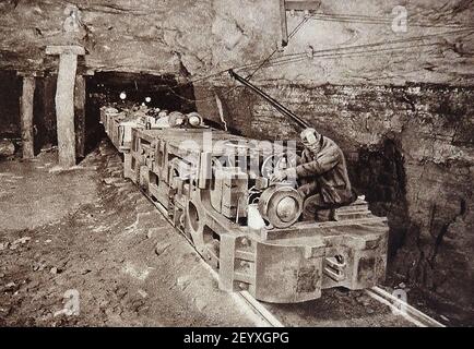 An early photograph in a coal mine showing the introduction of motorised trains to transport trucks of coal. Stock Photo