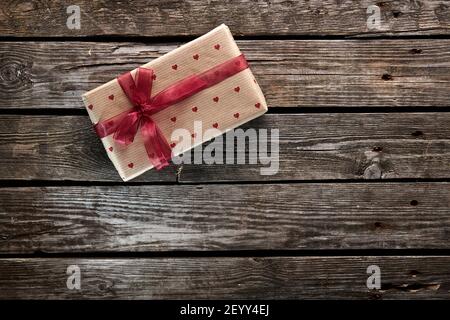 Gift box tied red ribbon with small hearts Stock Photo