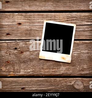 Blank instant photo frame on wooden background. Stock Photo