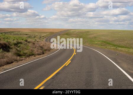 Paved Two Lane Road Highway Transportation White Clouds Blue Skky Stock Photo